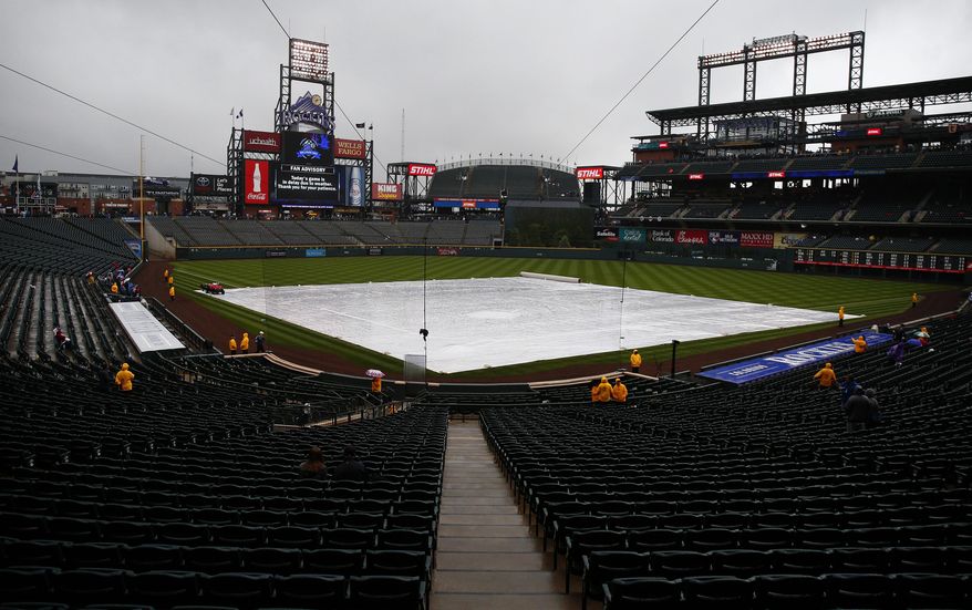 A weather delay is displayed on the scoreboard at Coors Field Wednesday, May 10, 2017, in Denver. The Chicago Cubs are scheduled to play the Colorado Rockies. (AP Photo/Jack Dempsey)