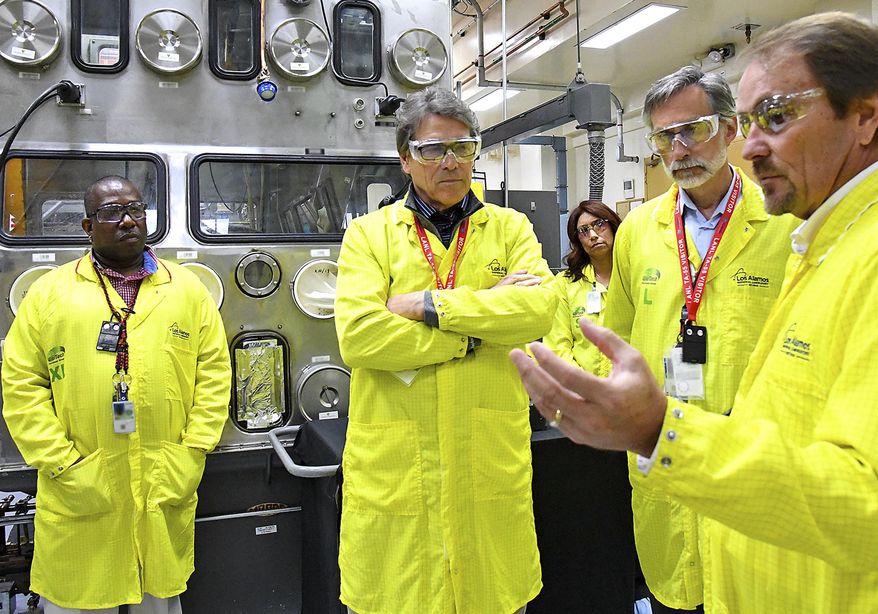 U.S Secretary of Energy Rick Perry, second from left, accompanied by Laboratory Director Charlie McMillan, second from right, learns about capabilities at the Los Alamos National Laboratory&#x27;s Plutonium Facility, from Jeff Yarbrough, right, Los Alamos Associate Director for Plutonium Science and Manufacturing, Wednesday, May 10, 2017, in Los Alamos, N.M. Perry says he will advocate for nuclear power as often and as strongly as he can as the nation looks for ways to fuel its economy and limit the effects of electricity generation on the environment. (Los Alamos National Laboratory via AP)