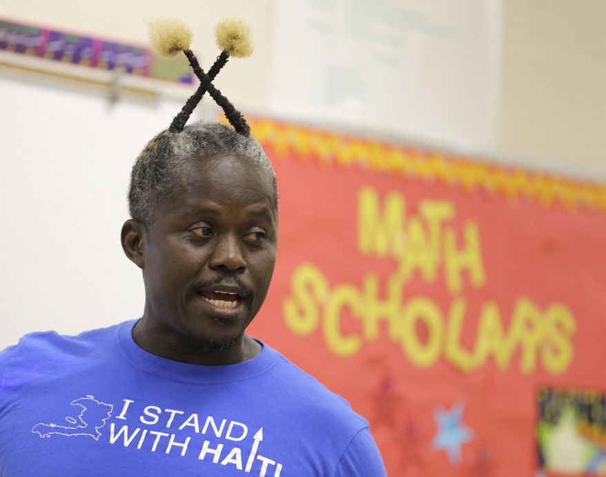 Haitian radio host and middle school teacher Salusa Basquin prepares a Geometry Bonus class for eighth grade students, Tuesday, May 9, 2017, in West Palm Beach, Fla. In recent weeks, he has been organizing rallies in West Palm Beach and Miami supporting extension of temporary protected status benefits for Haitians. As the Trump administration weighs extending humanitarian protections for thousands of Haitian immigrants, officials are digging for unusual information: How many have been convicted of crimes. (AP Photo/Alan Diaz)