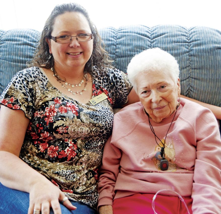 This photo taken April 4, 2017 shows Marla Knight, left, who has been bringing library books and companionship to Shirley Simpson, right, for about four years. The two spend some time together during the monthly visit at Simpsons house. (Lisa Romero /Daily Rocket-Miner via AP)