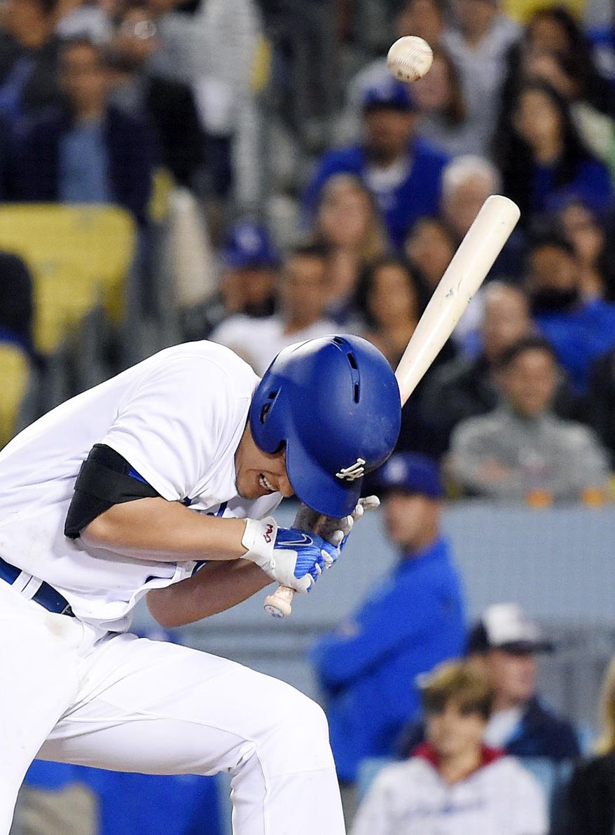 Los Angeles Dodgers' Corey Seager falls after being hit by a pitch during the seventh inning of the team's baseball game against the Pittsburgh Pirates, Tuesday, May 9, 2017, in Los Angeles. (AP Photo/Mark J. Terrill)