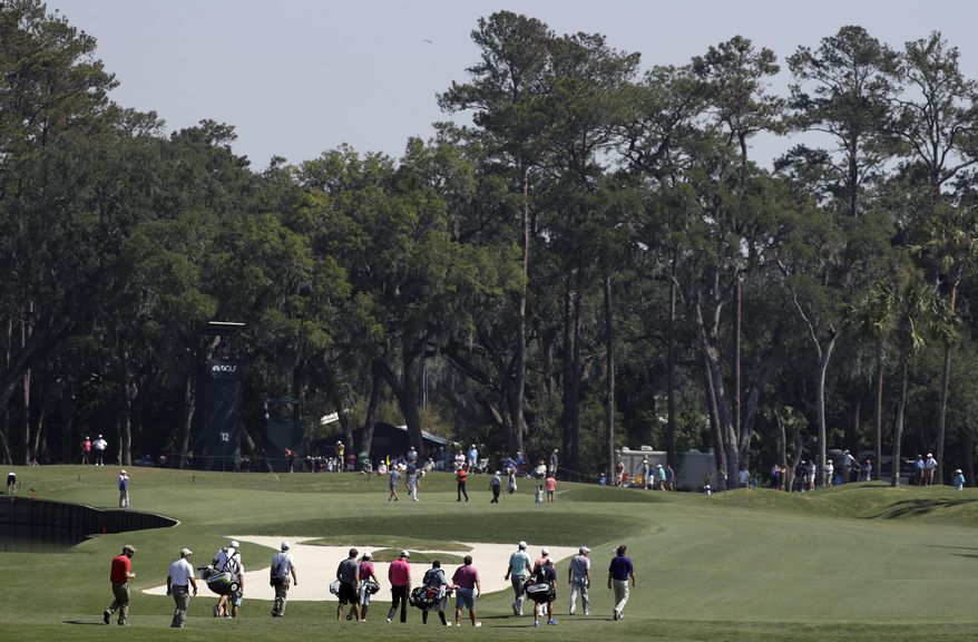 Golfers head up the 12th fairway towards the green during a practice round for The Players Championship golf tournament Wednesday, May 10, 2017, in Ponte Vedra Beach, Fla. Course designers have shortened the length on the hole making it reachable off the drive. (AP Photo/Chris O'Meara)