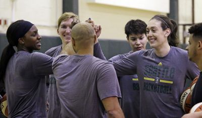 FILE - In this April 24, 2017, file photo, Seattle Storm&#39;s Crystal Langhorne, left, Carolyn Swords, Ramu Tokashiki and Breanna Stewart huddle as they finish shooting during a team basketball practice in Seattle. The whirlwind has stopped for Breanna Stewart. A year ago, Stewart was constantly in motion, from college, to the WNBA, to the Olympics and eventually overseas. After a much needed break, Stewart is ready for her second WNBA season with the Seattle Storm. (AP Photo/Elaine Thompson, File)