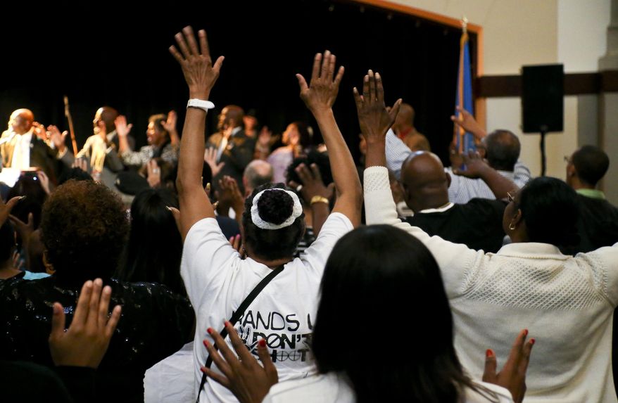 Community members attend a &amp;quot;Citywide Prayer and Call for Justice&amp;quot; for Terence Crutcher at the Jazz Hall of Fame on Wednesday, May 10, 2017, in Tulsa, Okla.  Prosecutors said during opening statements on Wednesday in Tulsa officer Betty Jo Shelby&#39;s manslaughter trial that she acted unreasonably when she fatally shot Crutcher, an unarmed black man, last year. (Jessie Wardarski /Tulsa World via AP)