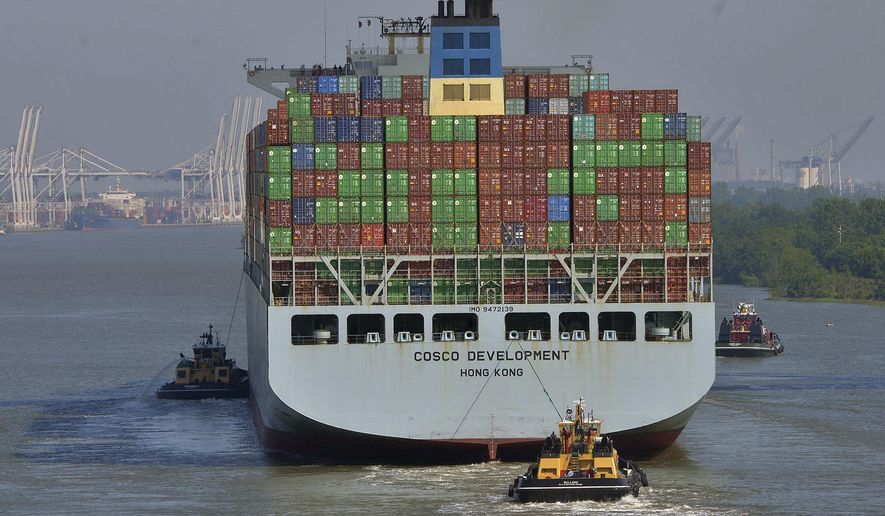 The container ship COSCO Development is guided under the Talmadge Bridge, Thursday morning, May 11, 2017, in Savannah, Ga, as the vessel sails up the Savannah River to the Port of Savannah. The ship is the largest vessel ever to call on the U.S. East Coast. (Steve Bisson/Savannah Morning News via AP)