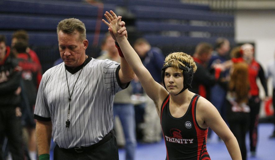 FILE - In this Feb. 18, 2017, file photo, Euless Trinity&#39;s Mack Beggs is announced as the winner of a semifinal match after Beggs pinned Grand Prairie&#39;s Kailyn Clay during the finals of the UIL Region 2-6A wrestling tournament at Allen High School in Allen, Texas. When Texas transgender wrestler Mack Beggs won a girls’ state championship, his victory drew jeers and complaints that his steroid therapy treatment had given him an unfair advantage against girls who risked injury just by getting on the mat with him, Now state lawmakers are pushing a bill that could deny Beggs, a Dallas area-junior, a chance to defend his title.  (Nathan Hunsinger/The Dallas Morning News via AP, File)