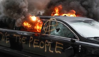 A parked limousine burns during a demonstration after the inauguration of President Donald Trump, Friday, Jan. 20, 2017, in Washington. (AP Photo/John Minchillo) ** FILE **