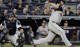 Houston Astros&#39; Brian McCann, right, follows through on a three-run home run during the fourth inning of a baseball game as New York Yankees catcher Gary Sanchez watches, Friday, May 12, 2017, in New York. (AP Photo/Frank Franklin II)
