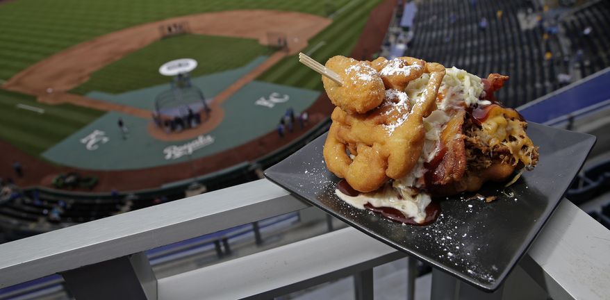 The Pulled Pork Patty Melt is seen at Kauffman Stadium before a baseball game between the Kansas City Royals and the Chicago White Sox on Tuesday, May 2, 2017, in Kansas City, Mo. The sandwich features pulled pork with cheese, bacon and cole slaw between a funnel cake bun and is topped with a jalapeno. (AP Photo/Charlie Riedel)
