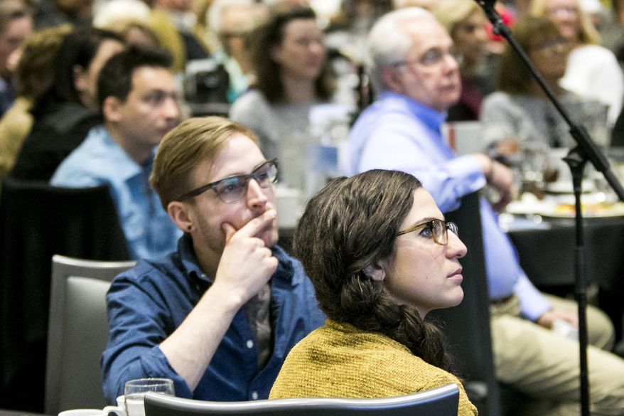 In this April 18, 2017 photo, Charlie Schweinler and Celeste Battista listen to architect Jeanne Gang speak during a luncheon at Giovanni's Restaurant & Convention Center in Rockford, Ill. The 1982 Belvidere High School graduate, among the world's most esteemed architects, came home today to discuss her art with a crowd of more than 300 people. (Arturo Pernandez/Rockford Register Star via AP)