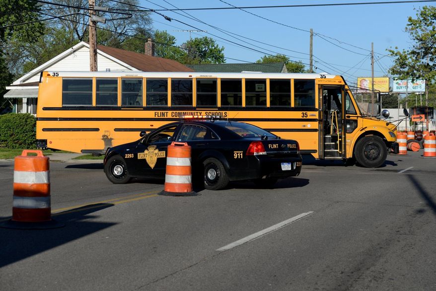 Flint Police work at the scene where a school bus collided with a car, Friday, May 12, 2017, at  the intersection of Atherton Road and Brunswick Avenue in Flint, Mich. (Callaghan O&#39;Hare/Mlive.com/The Flint Journal-MLive.com via AP)