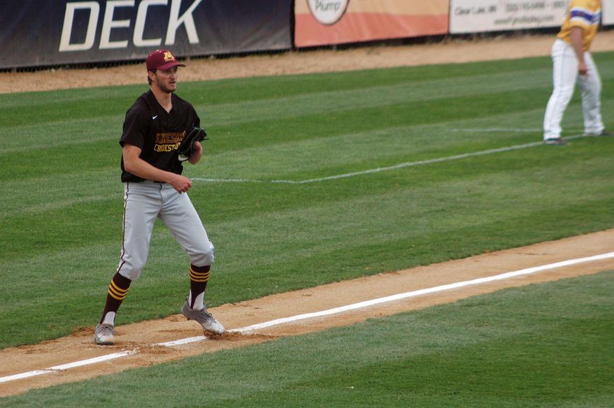 University of Minnesota-Crookston pitcher Parker Hanson is shown along the third base line after fielding a bunt during a college baseball game against Minnesota State in St. Cloud, Minn., Wednesday, May 10, 2017. Hanson’s success could be measured in his 90-mph fastball, his nasty slider or his start that vaulted his college baseball team into the playoffs. Or it could be marked by what he’s missing. Hanson was born without a left hand, but found a way to adapt at a young age so he could pitch, field, bat and play the game he loved. (AP Photo/Jeff Baenen)