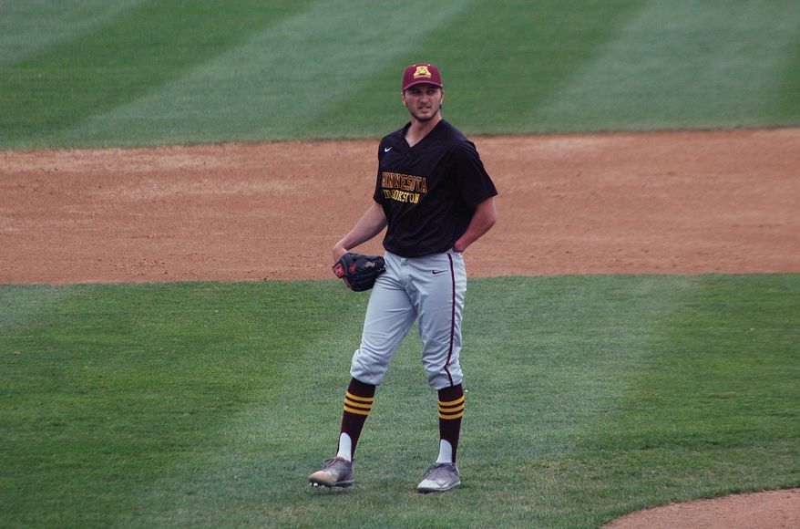 University of Minnesota-Crookston pitcher Parker Hanson stands off the mound between pitches during a college baseball game against Minnesota State in St. Cloud, Minn., Wednesday, May 10, 2017. Hanson’s success could be measured in his 90-mph fastball, his nasty slider or his start that vaulted his college baseball team into the playoffs. Or it could be marked by what he’s missing. Hanson was born without a left hand, but found a way to adapt at a young age so he could pitch, field, bat and play the game he loved. (AP Photo/Jeff Baenen)