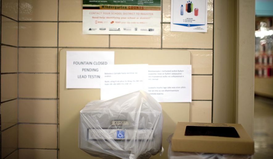 FILE - In this May 31, 2016, file photo, a water fountain is covered because of lead in the drinking water at Creston Elementary School in Portland, Ore. An upcoming $790 bond measure for the Portland Public Schools would be the largest in state history. Proponents say the money is desperately needed to repair and update infrastructure at the city's schools, which last summer made national headlines after toxic levels of lead were found in school water fountains. (Beth Nakamura/The Oregonian via AP, file)