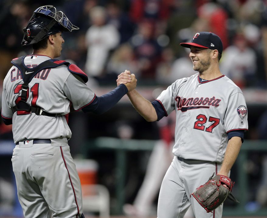 Minnesota Twins relief pitcher Brandon Kintzler, right, is congratulated by catcher Jason Castro after the Twins defeated the Cleveland Indians 1-0 in a baseball game, Friday, May 12, 2017, in Cleveland. (AP Photo/Tony Dejak)