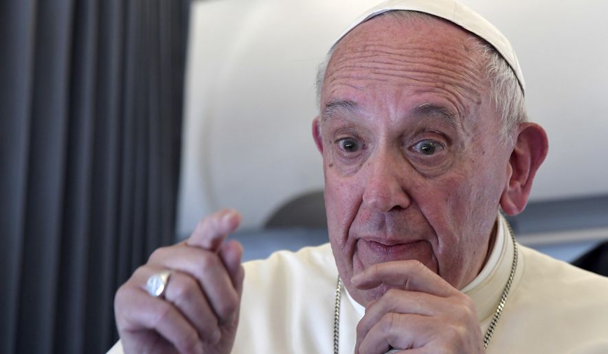 Pope Francis addresses journalists during the traditional press conference on his flight back to Rome, following a two-day visit at Fatima, Portugal, Saturday, May 13, 2017. Pope Francis added two Portuguese shepherd children to the roster of Catholic saints Saturday, honoring young siblings whose reported visions of the Virgin Mary 100 years ago turned the Portuguese farm town of Fatima into one of the world&#x27;s most important Catholic shrines. (Tiziana Fabi/Pool Photo via AP) ** FILE **