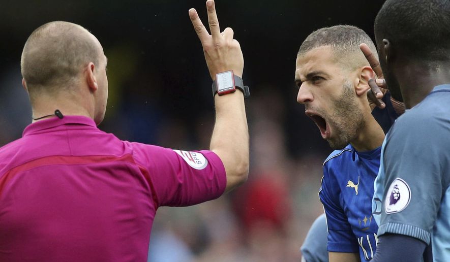 Referee Robert Madley, left,  gestures to Leicester City&#x27;s Islam Slimani after disallowing Riyad Mahrez&#x27;s goal from the penalty spot for a double hit, during the English Premier League soccer match between Manchester City and Leicester, at the Etihad Stadium, in Manchester, England, Saturday May 13, 2017. (Martin Rickett/PA via AP)