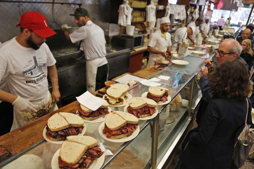 Orders are ready to go out at Katz's Delicatessen in New York, Thursday, May 11, 2017. The famed New York City restaurant that made a name for itself during World War II with the slogan "send a salami to your boy in the Army," is launching an expanded global delivery business that will allow people to ship its cured meats around the world. (AP Photo/Seth Wenig)
