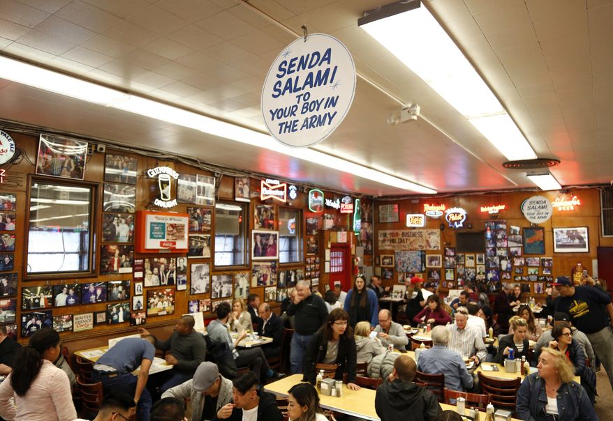 Diners enjoy eating at Katz's Delicatessen in New York, Thursday, May 11, 2017. The famed New York City restaurant that made a name for itself during World War II with the slogan "send a salami to your boy in the Army," is launching an expanded global delivery business that will allow people to ship its cured meats around the world. (AP Photo/Seth Wenig)