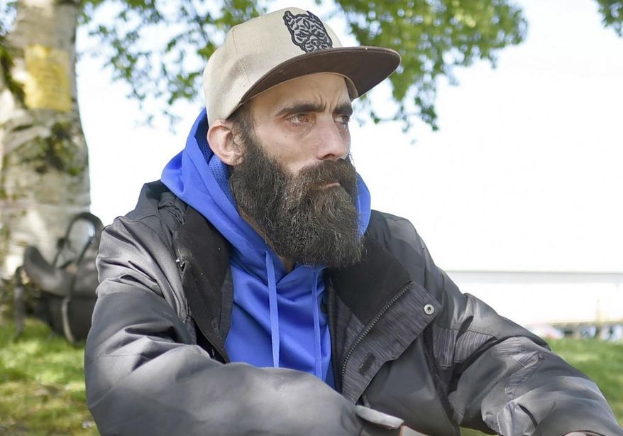 In this Wednesday May 3, 2017 photo, a man who wished to be identified only as Will recently took advantage of services offered by the Riverfolk non-profit group at People's Park near the downtown district in Astoria, Ore.. Riverfolk is also involved in trying to help the homeless population in the area obtain personal documents such as birth certificates and identification.(Colin Murphey/Daily Astorian via AP)