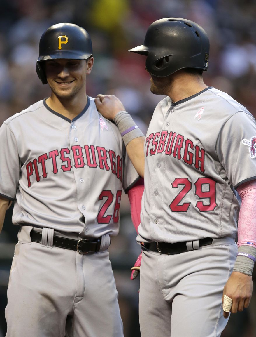 Pittsburgh Pirates Francisco Cervelli celebrates with Adam Frazier (26) after scoring a run during the sixth inning of the team's baseball game against the Arizona Diamondbacks, Saturday, May 13, 2017, in Phoenix. (AP Photo/Rick Scuteri)
