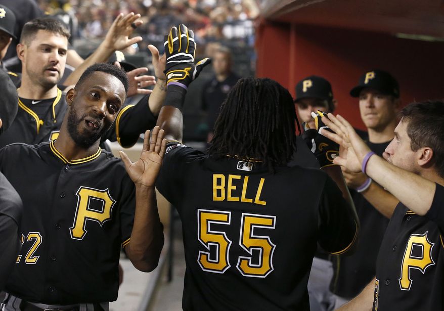 Pittsburgh Pirates' Josh Bell (55) celebrates his two-run home run against the Arizona Diamondbacks with teammates, including Andrew McCutchen, left, during the fourth inning of a baseball game Friday, May 12, 2017, in Phoenix. (AP Photo/Ross D. Franklin)