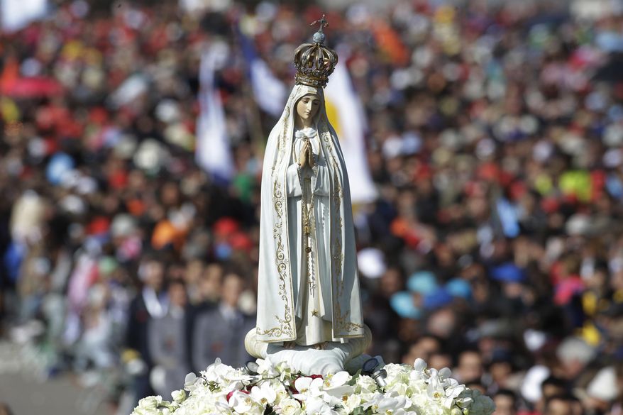The statue of the Virgin Mary is shoulder carried by faithful prior to the start of a mass at the Sanctuary of Our Lady of Fatima Saturday, May 13, 2017, in Fatima, Portugal. The pontiff will canonize on Saturday two poor, illiterate shepherd children whose visions of the Virgin Mary 100 years ago marked one of the most important events of the 20th-century Catholic Church. (AP Photo/Armando Franca)