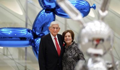 FILE - In this Wednesday, Sept. 16, 2015 file photo, Eli Broad and his wife, Edythe, stand for a photo amid Jeff Koons sculptures at his new museum called &amp;quot;The Broad&amp;quot; in downtown Los Angeles. Eli Broad, a charter school advocate who has contributed at least $3.7 million since 2007 to political efforts to expand charters, wrote a letter to senators calling for them to reject education secretary nominee Betsy DeVos, calling her “unprepared and unqualified.” (AP Photo/Richard Vogel)