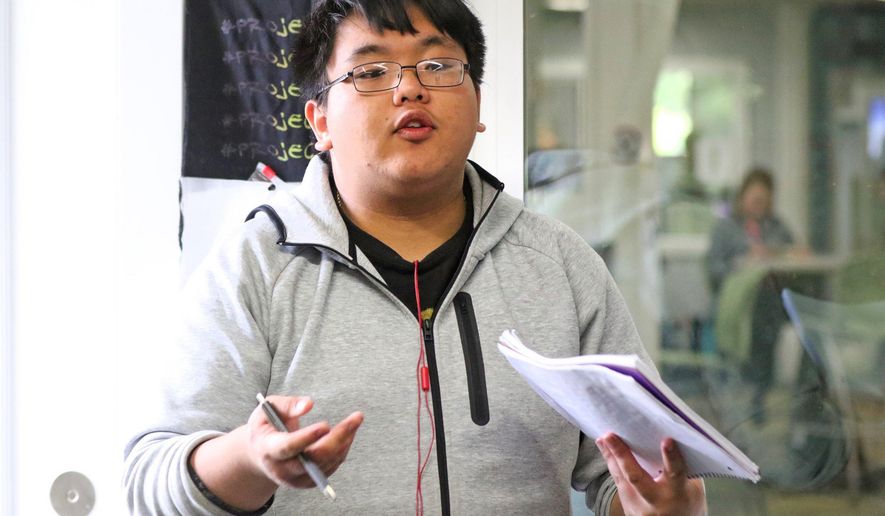 In this April 26, 2017 photo, Moses Shiong leads a discussion group at the Bellevue Boys and Girls club about a project in Bellevue, Wash. The group "Speak Up" helps teens speak up about their lives and struggles. (Greg Gilbert/The Seattle Times via AP)