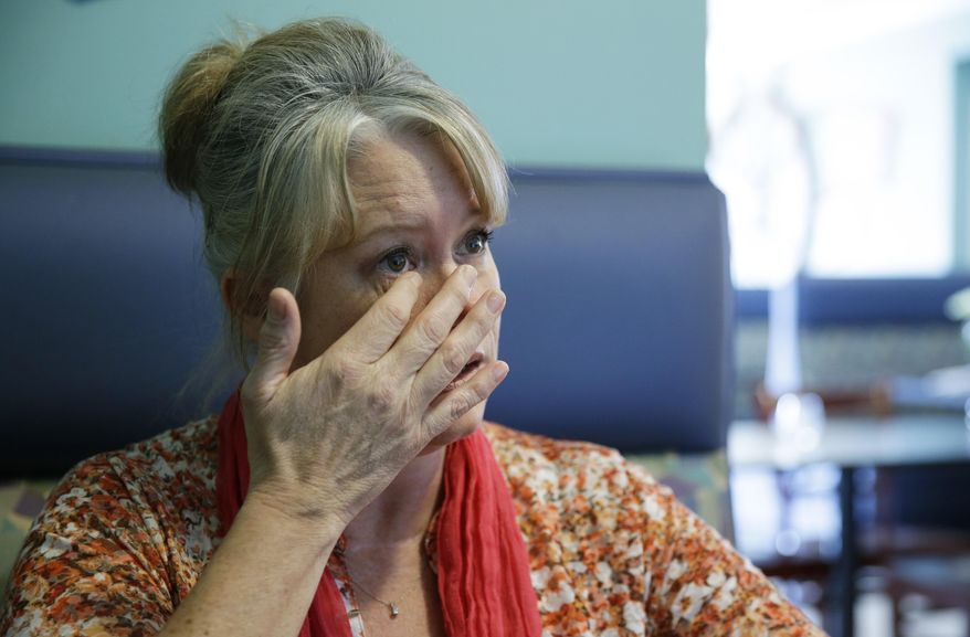 In this April 27, 2017 photo, Susan Jones wipes a tear as she talks about her husband, Martin Jones, while sitting in a restaurant in Long Beach, Wash. Martin Jones was convicted in the Feb. 13, 2010 shooting of Scott Johnson, then a Washington state trooper, in Long Beach, but his attorneys are now seeking a new trial. Johnson is now the Pacific County Sheriff. (AP Photo/Ted S. Warren)