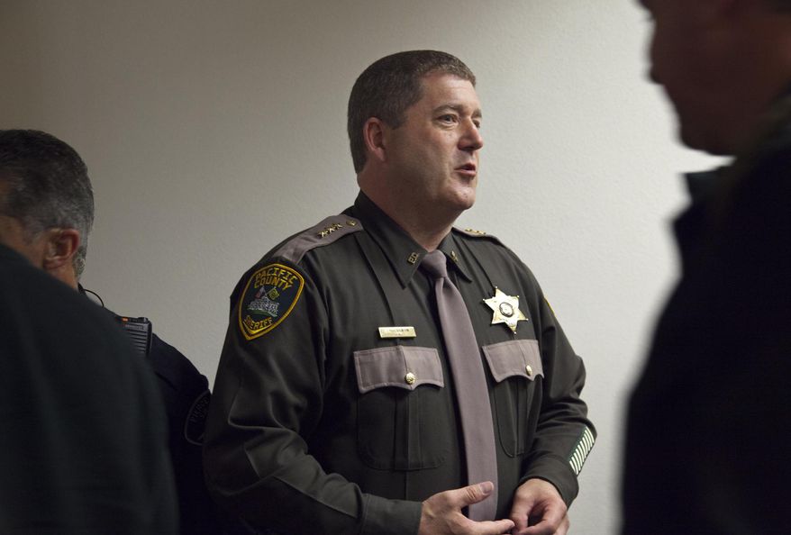 In this photo taken March 9, 2011, Pacific County Sheriff Scott Johnson is shown in Tacoma, Wash., following a sentencing hearing for Martin Jones, who was convicted of shooting Johnson in 2010 in Long Beach, Wash., when Johnson was a Washington state trooper. Jones' attorney is seeking a new trial, saying another man confessed to the shooting and that Johnson deliberately misidentified Jones. (Bill Wagner/The Daily News via AP)
