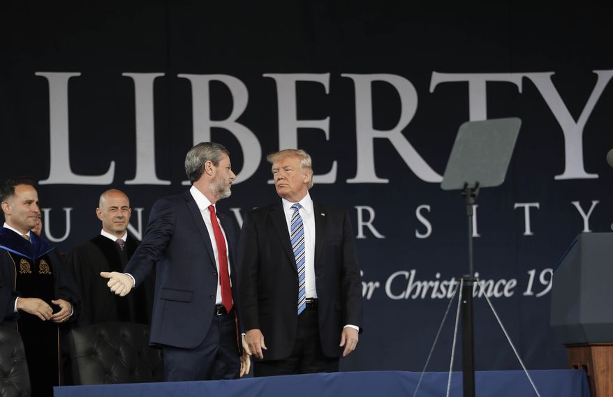 President Donald Trump, center, on stage with Liberty University President Jerry Falwell, left, after giving the commencement address for the Class of 2017 at Liberty University in Lynchburg, Va., Saturday, May 13, 2017. (AP Photo/Pablo Martinez Monsivais)