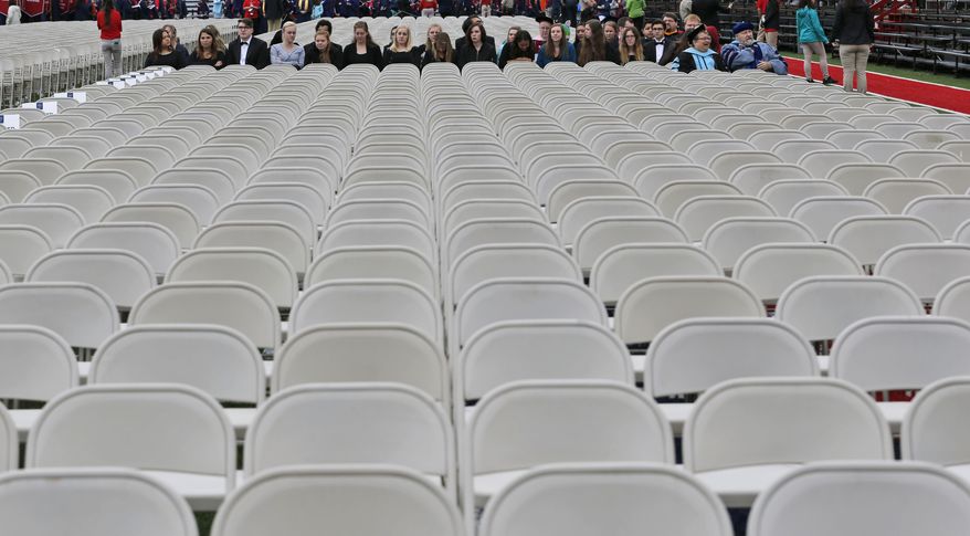 Liberty University commencement visitors wait for proceedings to start at the school in Lynchburg, Va., Saturday, May 13, 2017. (AP Photo/Steve Helber)