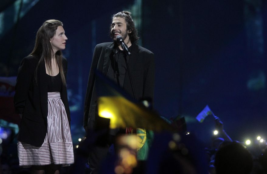 Salvador Sobral from Portugal, right, performs the song "Amar pelos dois" with his sister Luisa after winning the Final of the Eurovision Song Contest, in Kiev, Ukraine, Saturday, May 13, 2017. (AP Photo/Efrem Lukatsky)