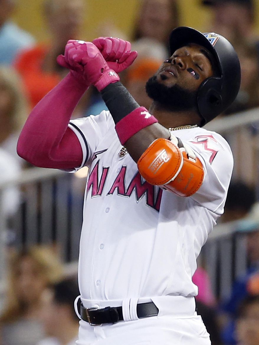 Miami Marlins' Marcell Ozuna celebrates after getting a base hit during the first inning of a baseball game against the Atlanta Braves, Sunday, May 14, 2017, in Miami. (AP Photo/Wilfredo Lee)