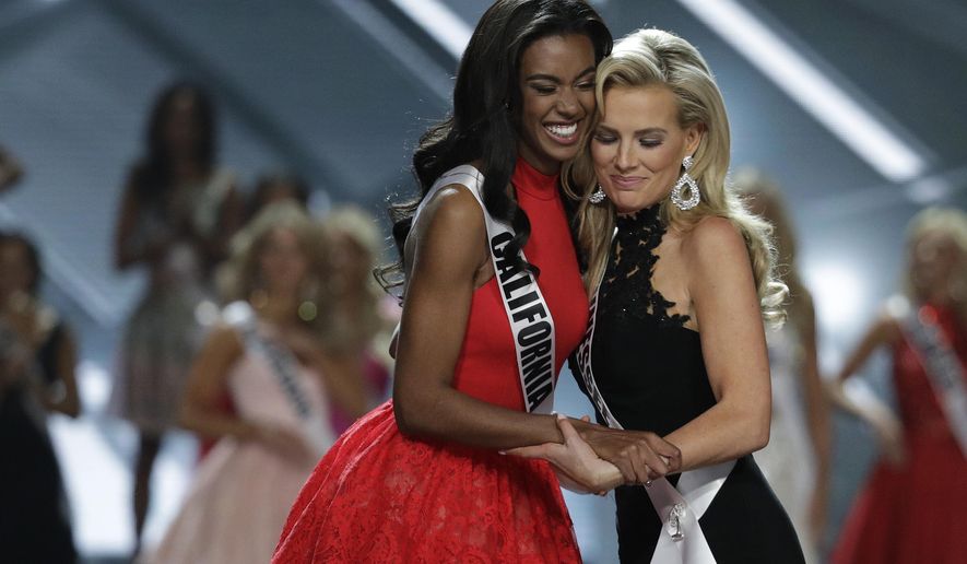 Miss California USA India Williams, left, and Miss Tennessee USA Allee-Sutton Hethcoat embrace after making the top 10 during the Miss USA contest Sunday, May 14, 2017, in Las Vegas. (AP Photo/John Locher)