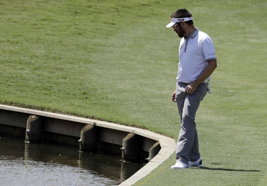 Louis Oosthuizen, of South Africa, looks down after his second shot of the fourth hole went in the water during the final round of The Players Championship golf tournament Sunday, May 14, 2017, in Ponte Vedra Beach, Fla. (AP Photo/Chris O&#39;Meara)