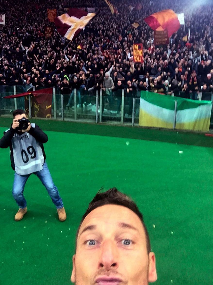 AS Roma’s Francesco Totti barely squeezes into the frame of his selfie after scoring against Lazio
