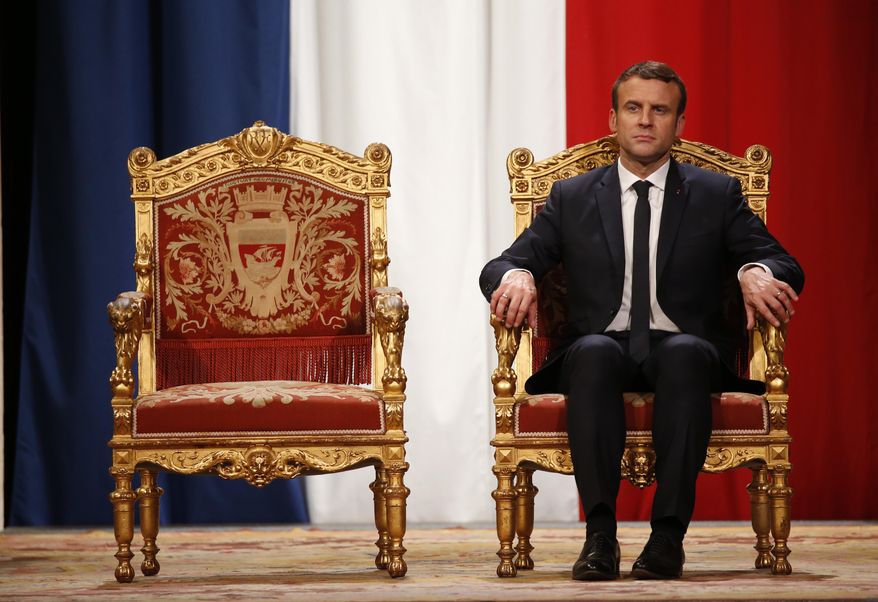 French President Emmanuel Macron listens as Paris Mayor Anne Hidalgo delivers her speech during a ceremony at the Hotel de Ville in Paris, France, Sunday, May 14, 2017. (Charles Platiau/Pool Photo via AP)
