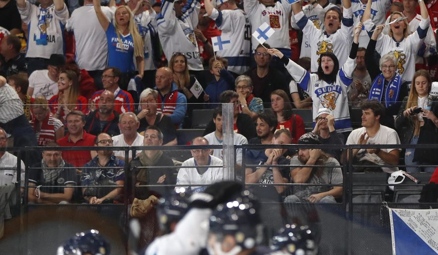 Finland&#39;s fans and players celebrate after scoring a goal during the Ice Hockey World Championships group B match between Switzerland and Finland in the AccorHotels Arena in Paris, France, Sunday, May 14, 2017. (AP Photo/Petr David Josek)