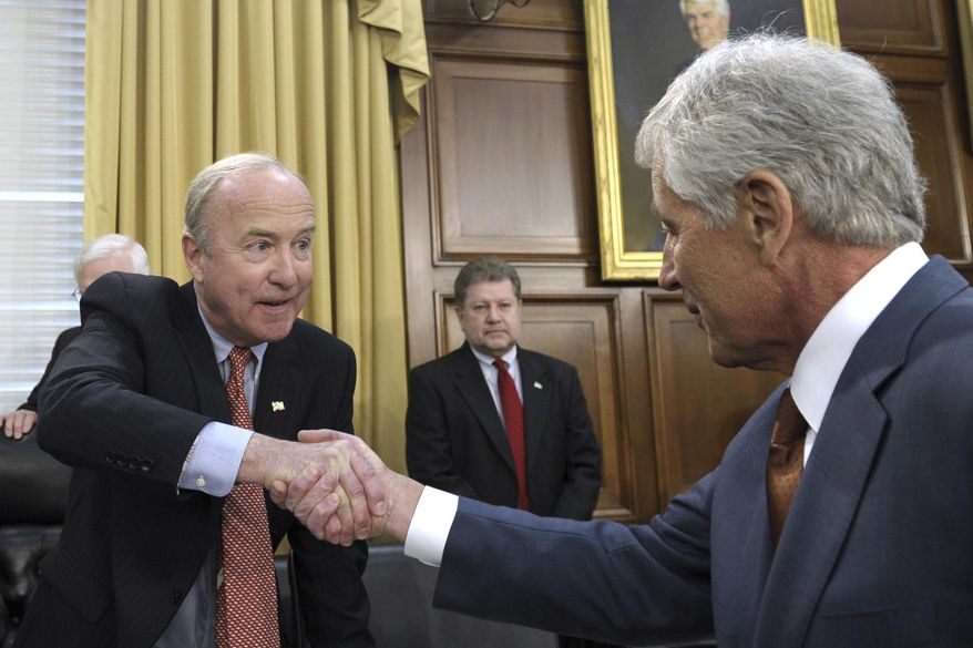 FILE – In this March 13, 2014, file photo, U.S. Rep. Rodney Frelinghuysen, left, R-N.J., chairman of the House Appropriations subcommittee on defense, shakes hands with Defense Secretary Chuck Hagel, right, prior to Hagel's testimony on the Defense Department's fiscal 2015 budget on Capitol Hill in Washington. Saily Avelenda, a New Jersey woman who joined a group urging Frelinghuysen to distance himself from President Donald Trump's policies, says she quit her job at Lakeland Bank after Frelinghuysen's fundraising letter to the bank included a handwritten note saying a "ringleader" of the protest movement worked there, Monday, May 15, 2017. (AP Photo/Susan Walsh, File)