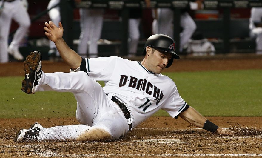 Arizona Diamondbacks' A.J. Pollock slides into home plate to score a run against the Pittsburgh Pirates during the fourth inning of a baseball game Friday, May 12, 2017, in Phoenix. (AP Photo/Ross D. Franklin)