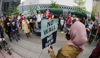Isra Ayesh, right, of Seattle, who is the organizing director of Americans for Refugees and Immigrants, leads a chant during a demonstration against President Donald Trump&#39;s revised travel ban, Monday, May 15, 2017, outside a federal courthouse in Seattle. A three-judge panel of the 9th U.S. Circuit Court of Appeals heard arguments Monday in Seattle over Hawaii&#39;s lawsuit challenging the travel ban, which would suspend the nation&#39;s refugee program and temporarily bar new visas for citizens of Iran, Libya, Somalia, Sudan, Syria and Yemen. (AP Photo/Ted S. Warren)