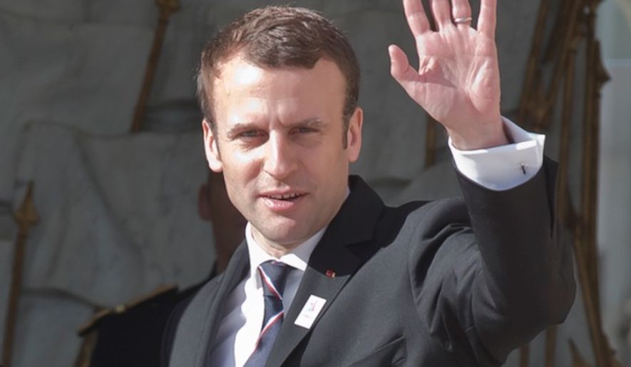 New French President Emmanuel Macron waves to the media after a meeting with the International Olympic Committee at the Elysee palace in Paris, France, May 16, 2017. France&#39;s new President Emmanuel Macron is hosting the International Olympic Committee to try to boost Paris&#39; bid to beat out Los Angeles in the heated race for the 2024 Games. (AP Photo/Michel Euler)