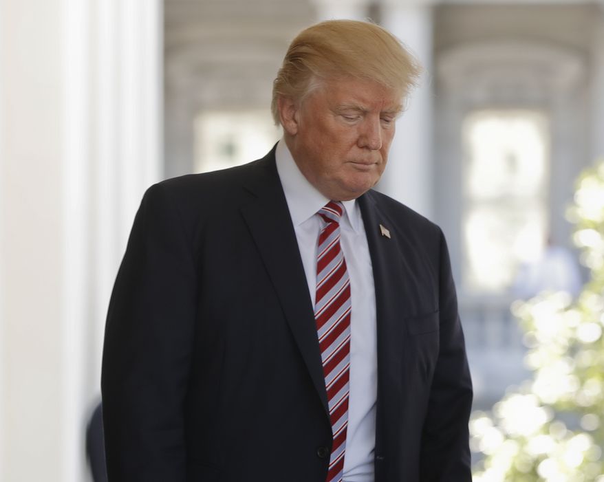 President Donald Trump walks back to the White House in Washington after escorting Turkish President Recep Tayyip Erdogan to his vehicle following Erdogan's visit, Tuesday, May 16, 2017. (AP Photo/Pablo Martinez Monsivais)