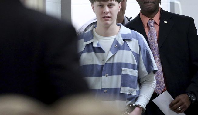 FILE - In this Monday, April 10, 2017, file photo, Dylann Roof enters the court room at the Charleston County Judicial Center to enter his guilty plea on murder charges in Charleston, S.C. Federal officials are for the first time showing videos of convicted the South Carolina church shooter&#x27;s jailhouse visits with his family on Tuesday, May 16. (Grace Beahm/The Post And Courier via AP, Pool, File)
