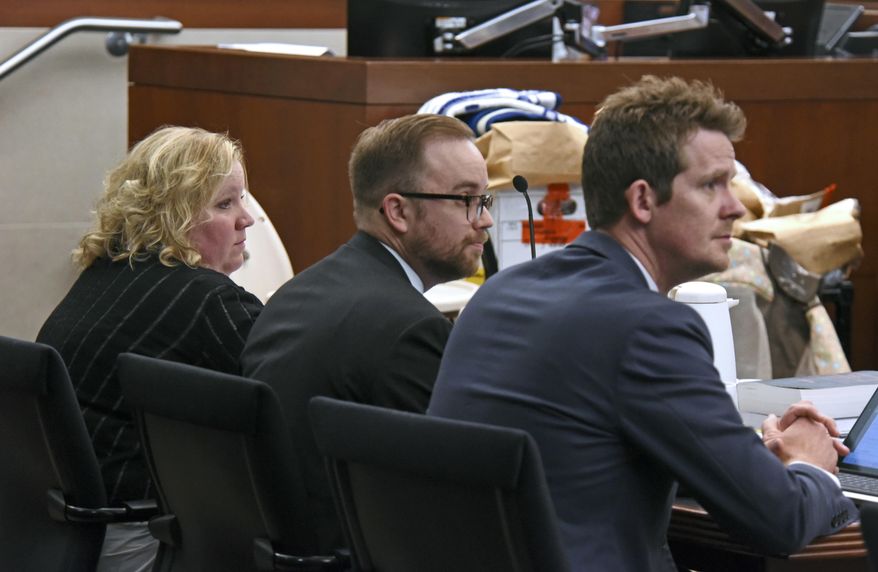 In this Friday, May 5, 2017 photo, Tisha Morley, left, sits with her attorneys, Jason Widdison, center, and Logan Bushell, right, during her trial in Ogden, Utah. Jurors on Tuesday, May 26, 2017, began deliberations on whether they believe the assertion from prosecutors that Morley, a northern Utah daycare owner, killed an 8-month-old boy by slamming his head on a changing table in frustration. (Sarah Welliver/Standard-Examiner via AP)