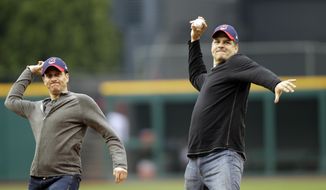 FILE - In this May 8, 2012, file photo, ESPN radio hosts Mike Greenberg, left, and Mike Golic throw out first pitches before a baseball game between the Cleveland Indians and the Chicago White Sox in Cleveland. The network announced Tuesday, May 16, 2017, that Greenberg would be leaving the longtime morning radio show he co-hosts with Golic to host a new morning TV show on ESPN TV that will premier Jan. 1. (AP Photo/Mark Duncan, File)