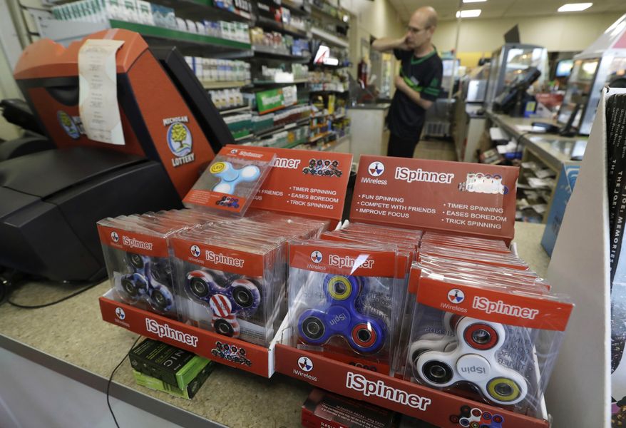 In a Tuesday, May 9, 2017, photo, fidget spinner toys are displayed at a 7-Eleven convenience store, in Warren, Mich. Stores can’t keep them in stock and parents are going crazy trying to find them. (AP Photo/Carlos Osorio)