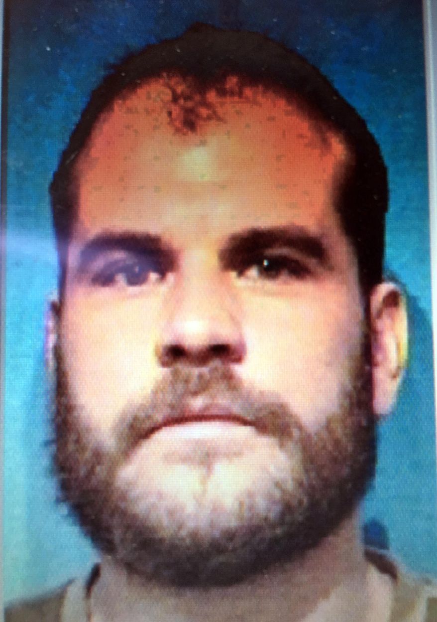 This undated booking photo provided by the Broadwater County Sheriff's Office shows Marshall Barrus, 38. Marshall Barrus was identified by authorities as the passenger in a vehicle driven by his father who, after a pursuit following a traffic stop that resulted in the death of Deputy Mason Moore, got out and shot at officers who returned fire. Marshall Barrus was shot in the head and taken to the hospital. The driver, Lloyd Barrus, 61, was arrested on suspicion of deliberate homicide. (Broadwater County Sheriff's Office via AP)